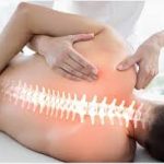 Physiotherapist massaging a patient's back with an overlaid graphic highlighting a healthy aligned spine anatomy