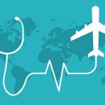 Teal flat vector illustration representing international medical tourism, featuring a world map background with a white stethoscope transitioning into a heartbeat line and an airplane icon.